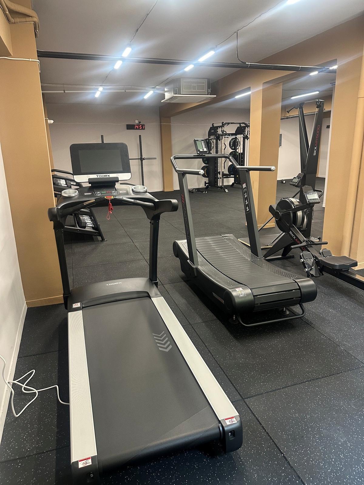 Open floor training space with mirrors and free weights